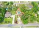 Expansive aerial view of a home featuring a private pool, surrounded by lush greenery and neighborhood charm at 4447 River Rd., Little River, SC 29566