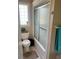 Bathroom featuring a toilet, shower with sliding glass doors and a small window that provides natural light at 4447 River Rd., Little River, SC 29566