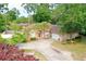 Elegant brick home featuring a circular driveway and mature palm trees, blending curb appeal with Southern charm at 4447 River Rd., Little River, SC 29566