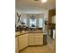 Functional kitchen with breakfast bar, tile floors, ample counter space, and abundant cabinets at 4447 River Rd., Little River, SC 29566