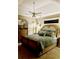 Serene main bedroom featuring a tray ceiling, plush bedding, and coordinating furniture at 4447 River Rd., Little River, SC 29566