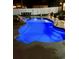Backyard swimming pool with custom lighting, patio area, and fenced perimeter for outdoor relaxation and entertainment at 4447 River Rd., Little River, SC 29566