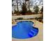 Inviting in-ground pool with stylish rock feature and underwater lighting, perfect for evening relaxation and entertainment at 4447 River Rd., Little River, SC 29566