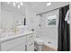 Bright bathroom with white cabinets, gold fixtures, a walk-in shower, and wood-look flooring at 4501 N Ocean Blvd., North Myrtle Beach, SC 29582