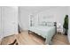 This bedroom offers bright and airy space with wood floors, white walls, and a large mirror at 4501 N Ocean Blvd., North Myrtle Beach, SC 29582