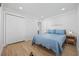 Comfortable bedroom with white walls, a blue quilt, and wood-look floors at 4501 N Ocean Blvd., North Myrtle Beach, SC 29582