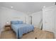 Bright bedroom with wood-look floors, white walls, and closet access at 4501 N Ocean Blvd., North Myrtle Beach, SC 29582