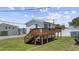 Stylish two-story home with a spacious wooden deck and staircase, perfect for relaxing and enjoying the outdoors at 4501 N Ocean Blvd., North Myrtle Beach, SC 29582