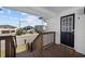 Front porch with a black front door, wood railings, and views of the street and ocean at 4501 N Ocean Blvd., North Myrtle Beach, SC 29582