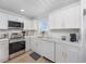 Bright kitchen with white cabinets, stainless steel appliances, and quartz countertops at 4501 N Ocean Blvd., North Myrtle Beach, SC 29582