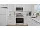Modern kitchen with white cabinets, stainless steel appliances, and quartz countertops at 4501 N Ocean Blvd., North Myrtle Beach, SC 29582