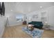 Cozy living room with white walls, a large window, and a modern sofa and rug at 4501 N Ocean Blvd., North Myrtle Beach, SC 29582