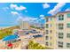 Coastal balcony view of beach, parking, and neighboring buildings, offering the best of vacation living at 4525 S Ocean Blvd. # 406, North Myrtle Beach, SC 29582