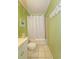 Bathroom with a tub and shower, toilet, and sink with vanity, all in a cheerful green color scheme at 4525 S Ocean Blvd. # 406, North Myrtle Beach, SC 29582