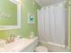 Bright bathroom features a tub with shower, sink with mirror, and coastal themed wall decor at 4525 S Ocean Blvd. # 406, North Myrtle Beach, SC 29582