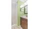 Bathroom features a vanity with dark wood cabinets, a shower with curtain, and lime green painted walls at 4525 S Ocean Blvd. # 406, North Myrtle Beach, SC 29582