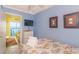 Bright bedroom with a TV, adjacent living space, and a beach-themed decor at 4525 S Ocean Blvd. # 406, North Myrtle Beach, SC 29582