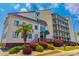 Inviting condo building featuring manicured landscaping and classic architectural elements at 4525 S Ocean Blvd. # 406, North Myrtle Beach, SC 29582