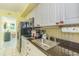 Kitchen featuring white cabinetry, tile backsplash, and essential appliances at 4525 S Ocean Blvd. # 406, North Myrtle Beach, SC 29582