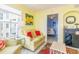 Cozy living room with bright yellow walls, comfortable seating, and a view into the bedroom at 4525 S Ocean Blvd. # 406, North Myrtle Beach, SC 29582