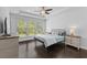 Cozy bedroom with a tray ceiling, ceiling fan, and a large window offering natural light at 4555 Weekly Dr, Myrtle Beach, SC 29579