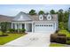 Charming single-Gathering home featuring a well-manicured lawn and a two-car garage at 4555 Weekly Dr, Myrtle Beach, SC 29579
