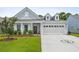 Charming single-Gathering home featuring a well-manicured lawn, front porch and a two-car garage at 4555 Weekly Dr, Myrtle Beach, SC 29579