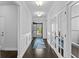 Elegant entryway with hardwood floors, wainscoting, and an open view into the front yard at 4555 Weekly Dr, Myrtle Beach, SC 29579