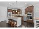 Kitchen with a granite-topped island, dark cabinetry, stainless steel appliances, and bar stool seating at 4555 Weekly Dr, Myrtle Beach, SC 29579