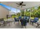Screened porch with comfortable seating, ceiling fan, and views of the fenced backyard and surrounding landscape at 4555 Weekly Dr, Myrtle Beach, SC 29579