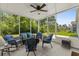 Relaxing sunroom with wicker furniture, blue cushions, and serene views of the lush backyard at 4555 Weekly Dr, Myrtle Beach, SC 29579