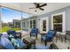 Comfortable screened-in porch featuring blue cushioned wicker furniture and serene outdoor views at 4555 Weekly Dr, Myrtle Beach, SC 29579