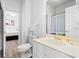 Bright bathroom with white fixtures and an attached bedroom at 4705 Wild Iris Dr. # 201, Myrtle Beach, SC 29577