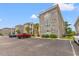 Exterior of condos with brick facade, parking spaces, and well maintained landscaping at 4705 Wild Iris Dr. # 201, Myrtle Beach, SC 29577