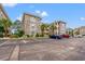 Exterior of condos with brick facade, parking spaces, and well maintained landscaping at 4705 Wild Iris Dr. # 201, Myrtle Beach, SC 29577