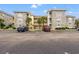 Exterior of condos with brick facade, parking spaces, and well maintained landscaping at 4705 Wild Iris Dr. # 201, Myrtle Beach, SC 29577