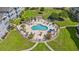 Aerial view of community pool, with seating and landscaping, surrounded by green grass and buildings at 4705 Wild Iris Dr. # 201, Myrtle Beach, SC 29577