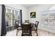 Dining area featuring a round table, four chairs, and natural light from sliding glass doors at 4705 Wild Iris Dr. # 201, Myrtle Beach, SC 29577