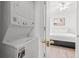 Bright laundry room with stacked washer and dryer, adjacent to the main bedroom at 4705 Wild Iris Dr. # 201, Myrtle Beach, SC 29577