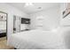 Spacious main bedroom with a white queen bed, dresser, TV, and closet at 4705 Wild Iris Dr. # 201, Myrtle Beach, SC 29577