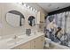 Well-lit bathroom featuring double sinks, a shower with artful curtain, and round mirrors at 4878 Luster Leaf Circle # 102, Myrtle Beach, SC 29577