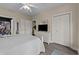 Tranquil bedroom features a white bed, grey wood floors, and ample closet space with storage at 4878 Luster Leaf Circle # 102, Myrtle Beach, SC 29577