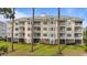 Multi-story building featuring multiple balconies, showcasing classic architectural design and outdoor living spaces at 4878 Luster Leaf Circle # 102, Myrtle Beach, SC 29577