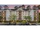 Inviting three-story condo building with white balconies and well-manicured landscaping and parking at 4878 Luster Leaf Circle # 102, Myrtle Beach, SC 29577