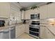 Bright kitchen features stainless steel appliances and cream-colored cabinets, perfect for cooking at 4878 Luster Leaf Circle # 102, Myrtle Beach, SC 29577