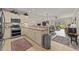 Open kitchen view with stainless appliances, bar seating, and stylish dining area and lighting fixture at 4878 Luster Leaf Circle # 102, Myrtle Beach, SC 29577