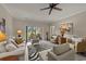 Bright living room with neutral furniture, zebra print rug, and sliding door to outdoor patio at 4878 Luster Leaf Circle # 102, Myrtle Beach, SC 29577