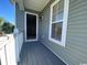 View of the outdoor balcony featuring painted wood flooring and white railings, a perfect spot to relax and enjoy fresh air at 493 Emerson Dr., Myrtle Beach, SC 29579