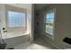 Modern bathroom features marble floors, separate soaking tub, and a tiled shower with black fixtures at 493 Emerson Dr., Myrtle Beach, SC 29579