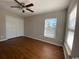 This bedroom features wood floors, a ceiling fan and a large window at 493 Emerson Dr., Myrtle Beach, SC 29579